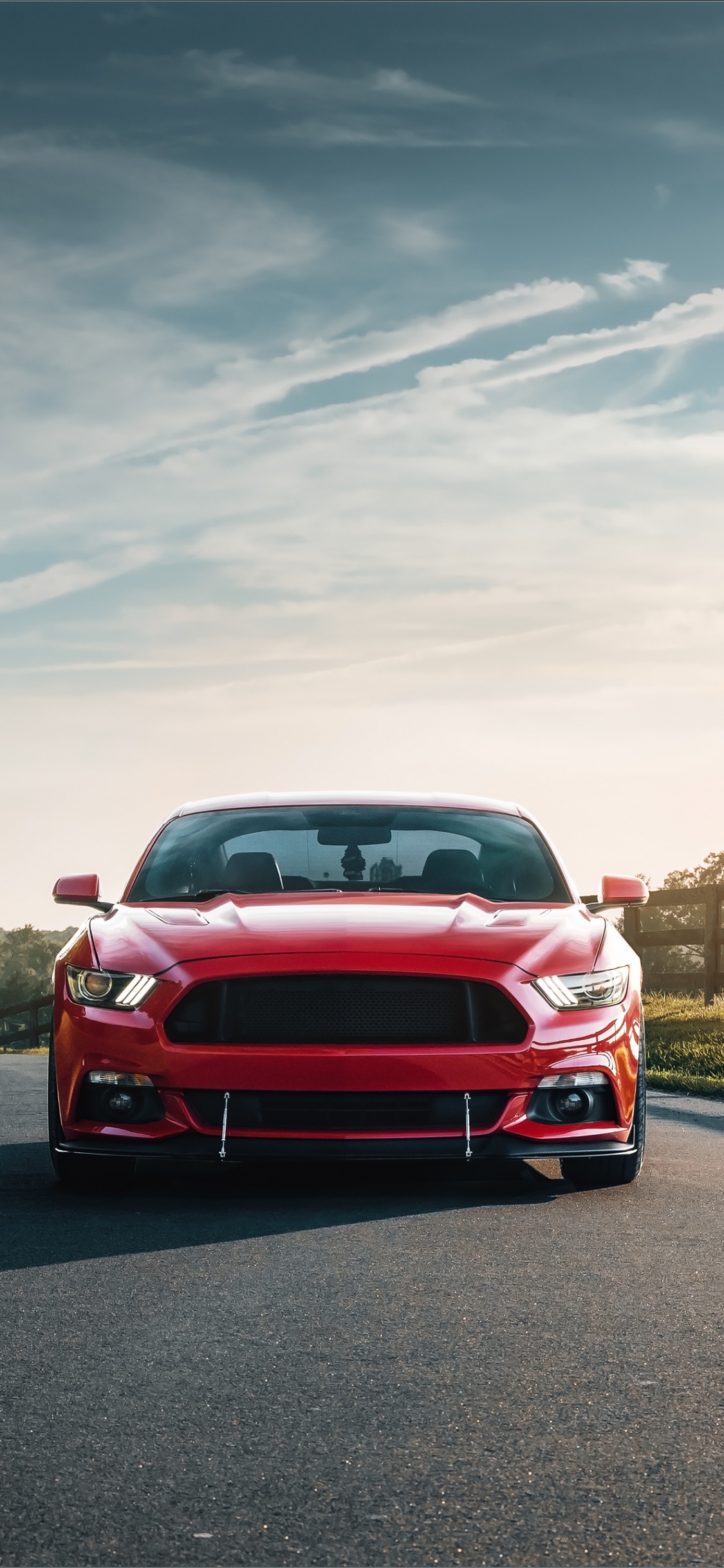Voiture Rouge Sur la Route Pendant la Journée. Wallpaper in 1125x2436 Resolution