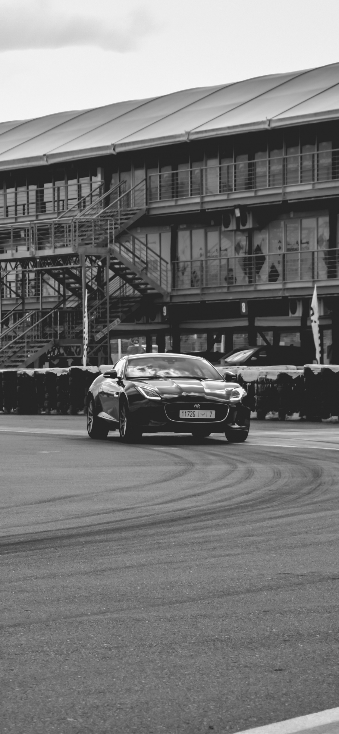 Grayscale Photo of Cars on Road. Wallpaper in 1125x2436 Resolution