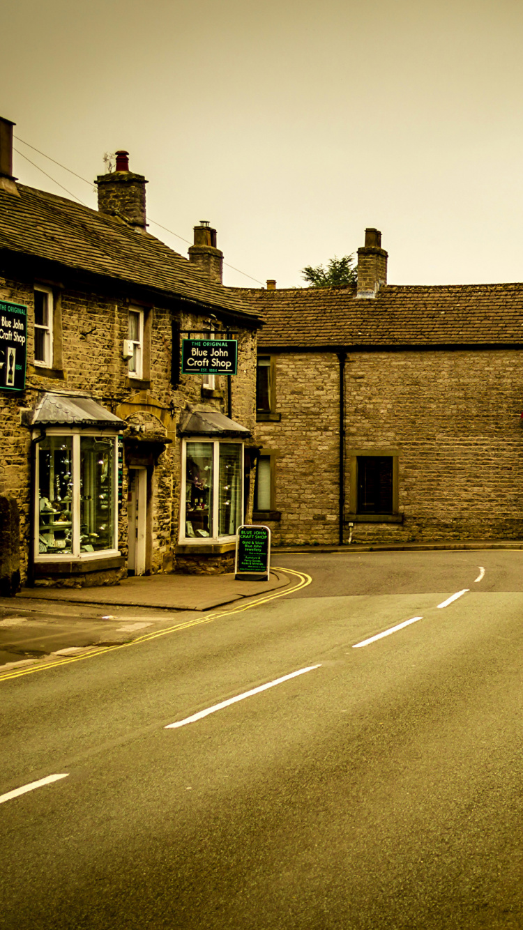 Brown Brick Building Beside Road. Wallpaper in 750x1334 Resolution