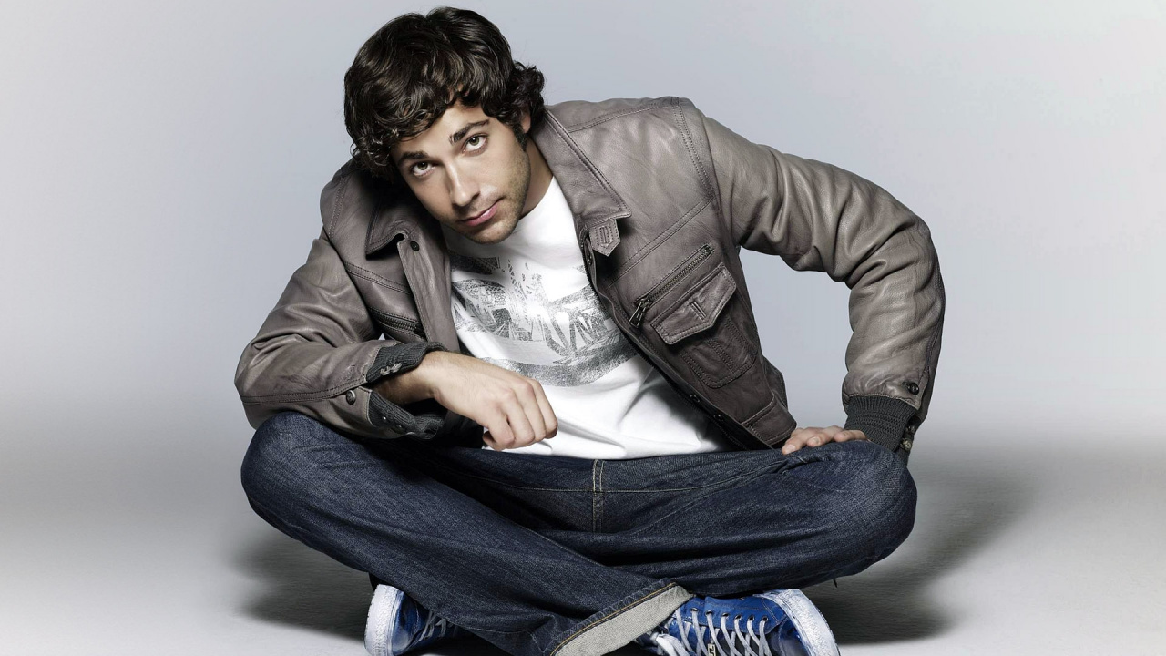 Man in Gray Leather Jacket and Blue Denim Jeans Sitting on Floor. Wallpaper in 1280x720 Resolution
