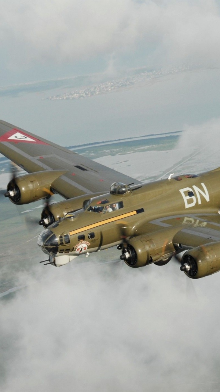 Yellow and Red Jet Plane Flying Over The Clouds During Daytime. Wallpaper in 720x1280 Resolution