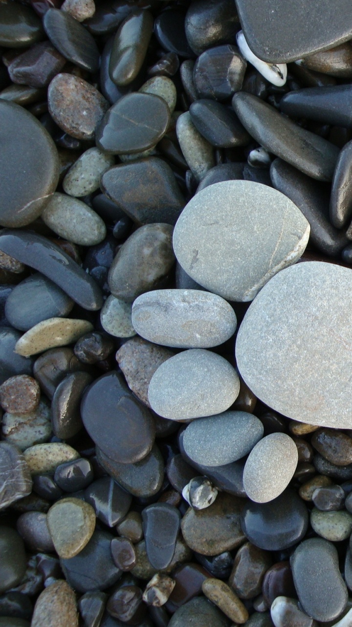 Heart Shaped Gray Stone on Gray and Black Stones. Wallpaper in 720x1280 Resolution