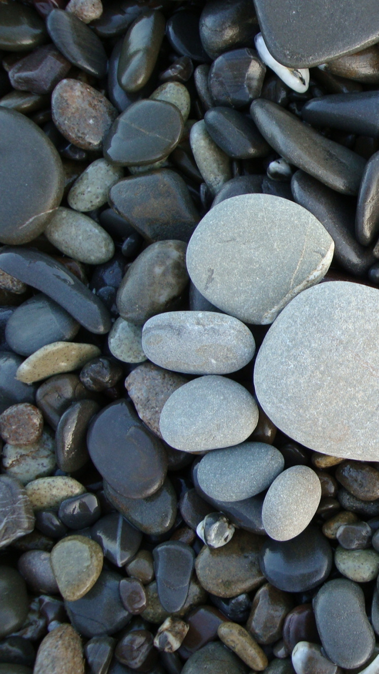 Heart Shaped Gray Stone on Gray and Black Stones. Wallpaper in 750x1334 Resolution