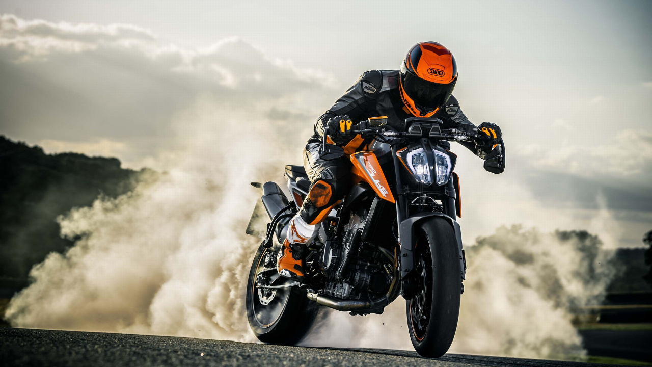 Man in Orange Helmet Riding Black Sports Bike. Wallpaper in 1280x720 Resolution