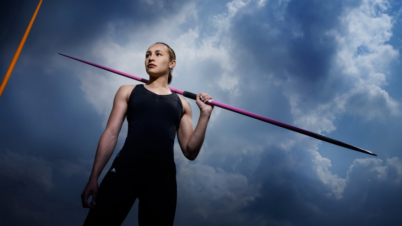 Woman in Black Tank Top and Black Pants Holding Red and White Stick. Wallpaper in 1280x720 Resolution