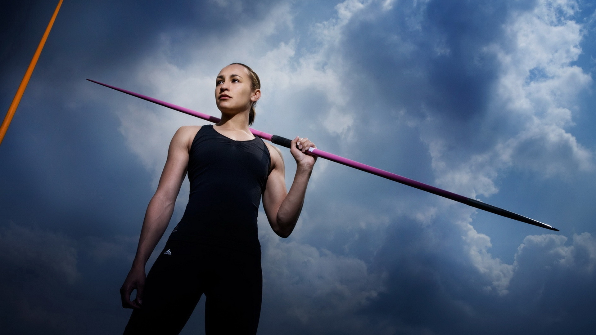 Woman in Black Tank Top and Black Pants Holding Red and White Stick. Wallpaper in 1920x1080 Resolution