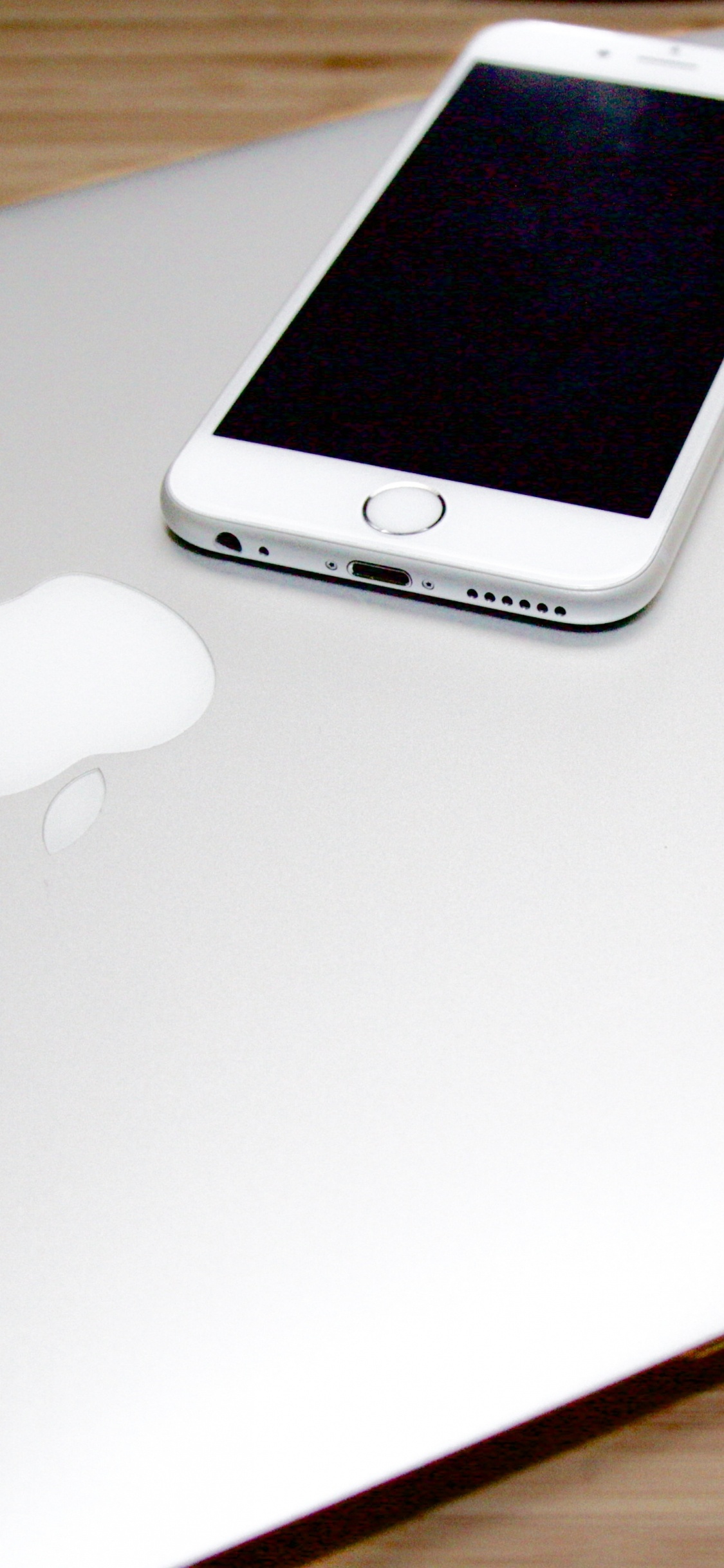 Silver Iphone 6 on Macbook. Wallpaper in 1125x2436 Resolution