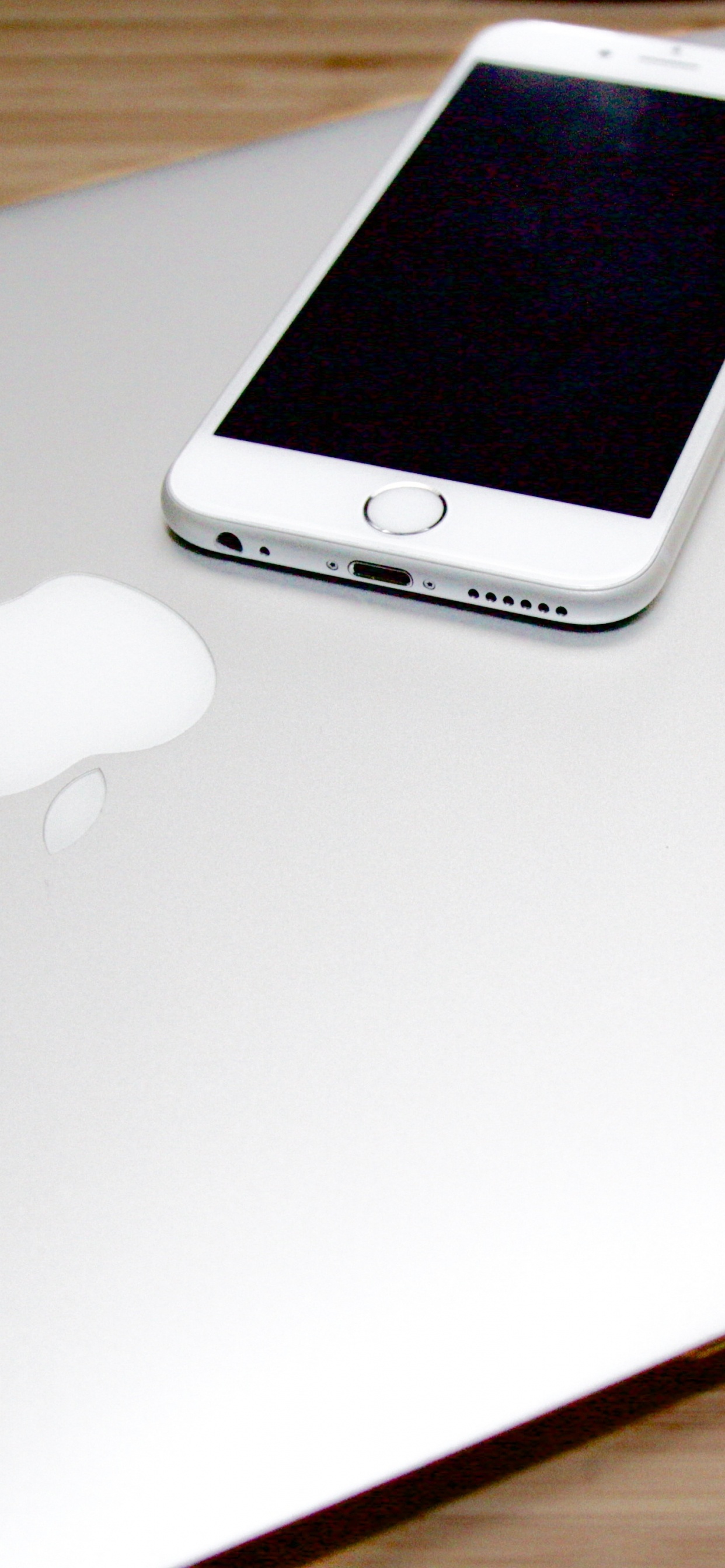 Silver Iphone 6 on Macbook. Wallpaper in 1242x2688 Resolution
