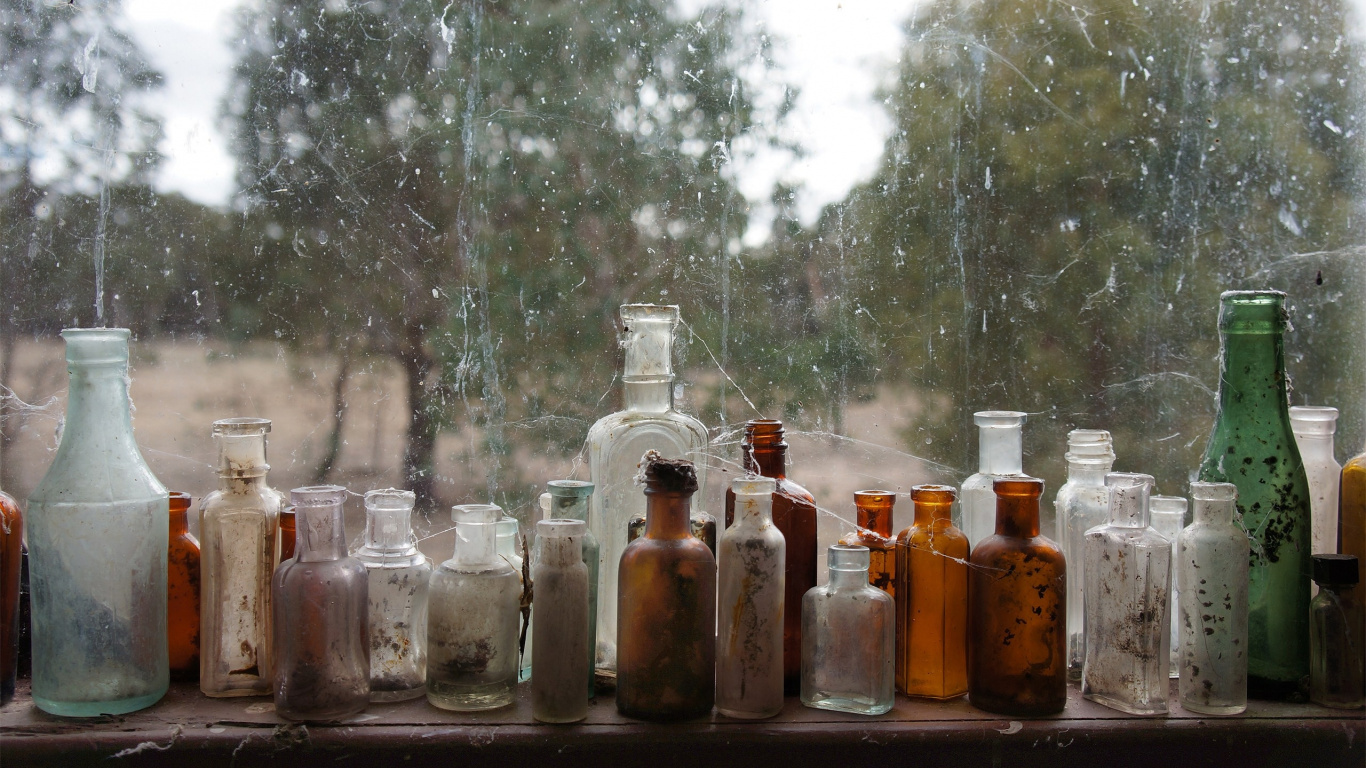Clear Glass Bottles on Brown Wooden Table. Wallpaper in 1366x768 Resolution