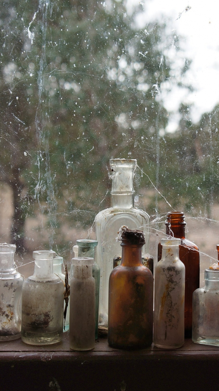 Clear Glass Bottles on Brown Wooden Table. Wallpaper in 750x1334 Resolution