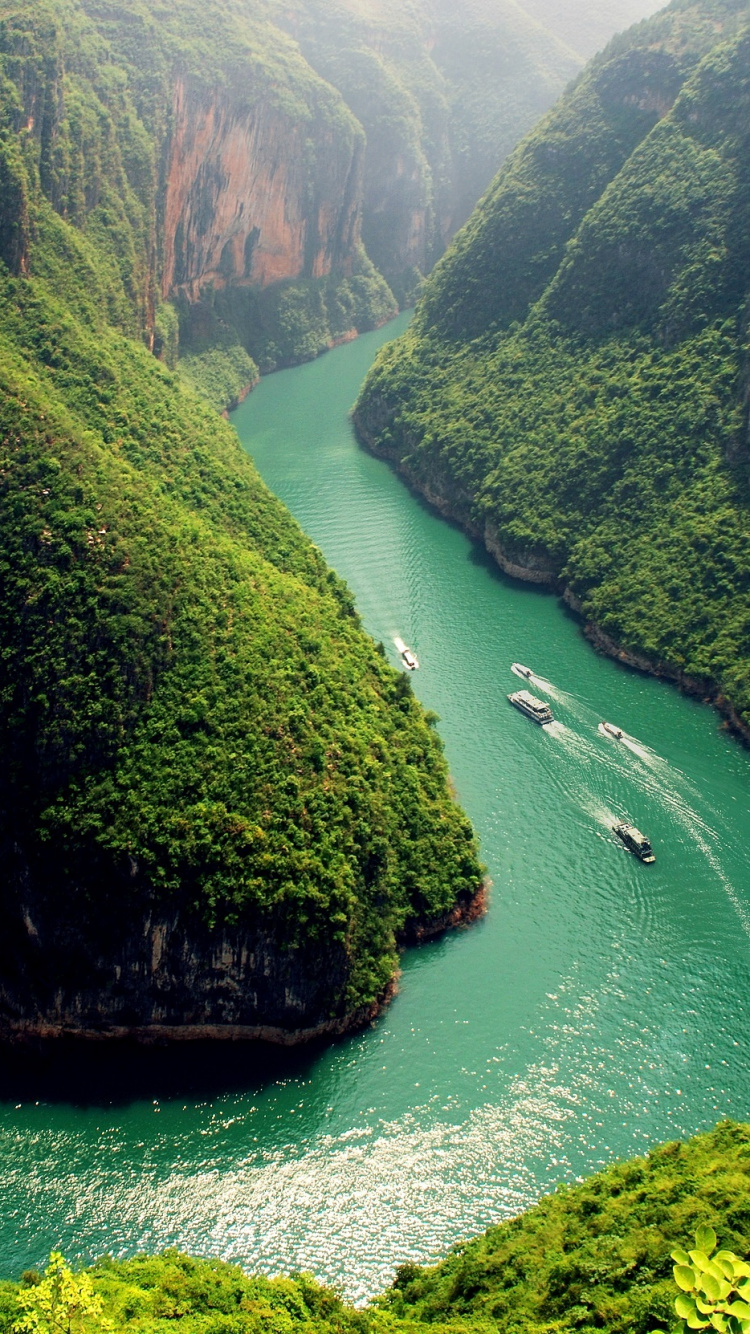 Green and Brown Mountain Beside Body of Water During Daytime. Wallpaper in 750x1334 Resolution