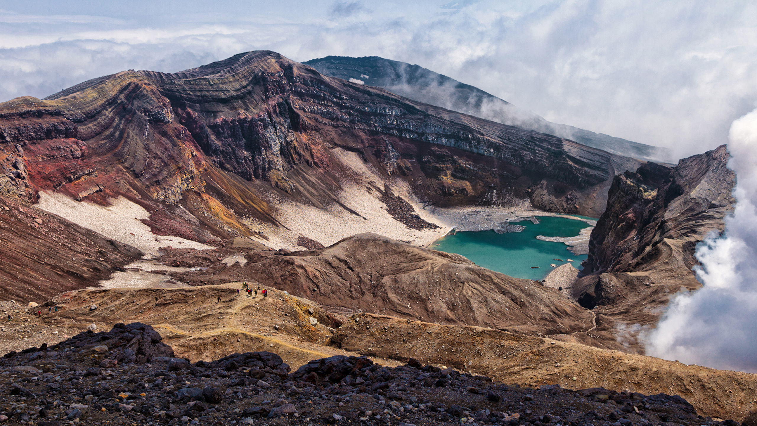 Brown and Gray Mountain Near Body of Water During Daytime. Wallpaper in 2560x1440 Resolution