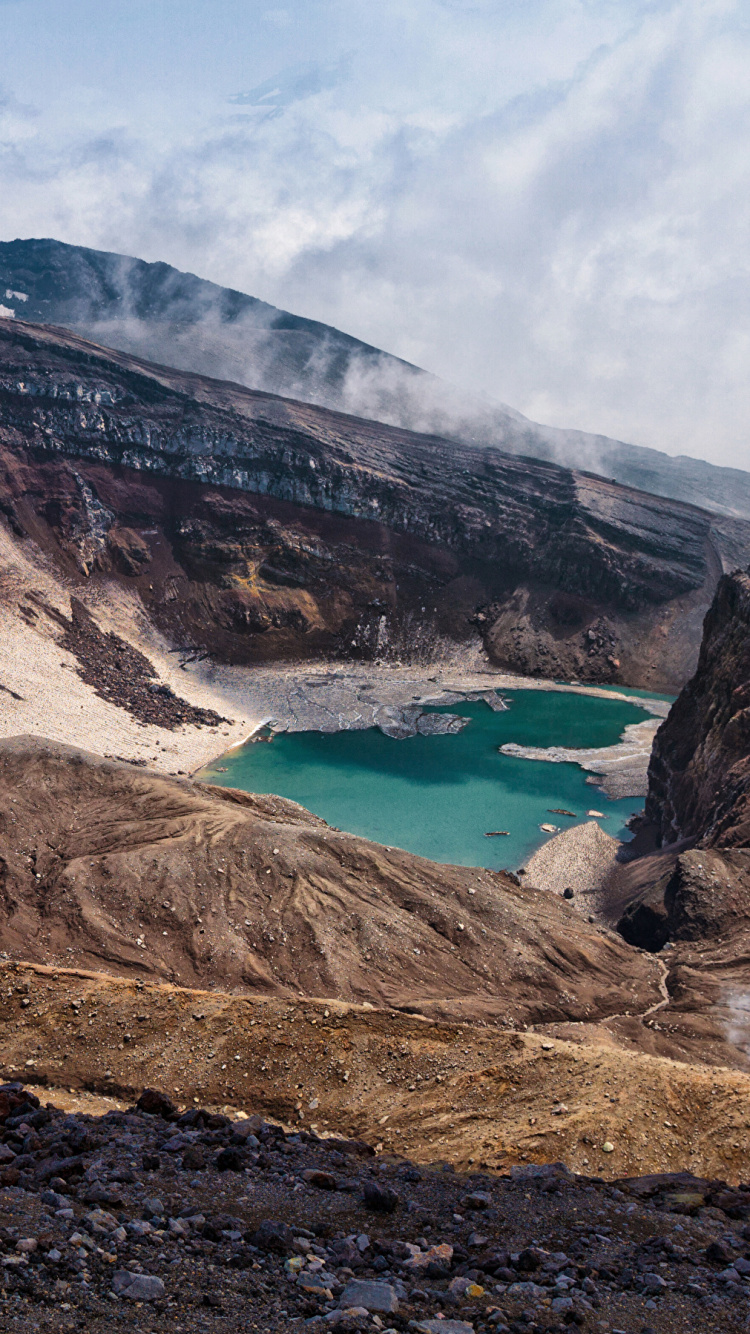 Brown and Gray Mountain Near Body of Water During Daytime. Wallpaper in 750x1334 Resolution
