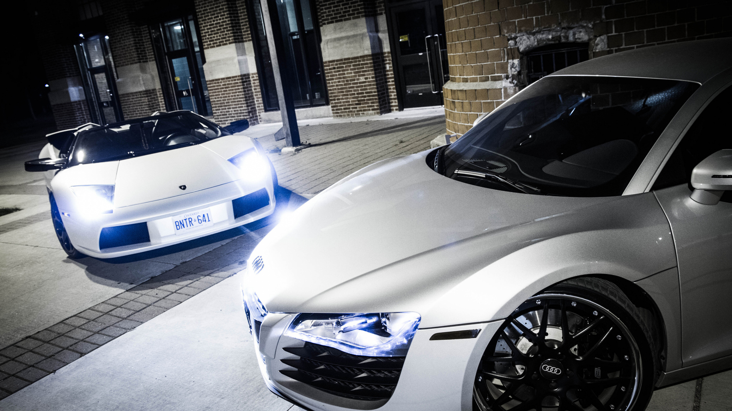 White Porsche 911 Parked Near Building. Wallpaper in 2560x1440 Resolution