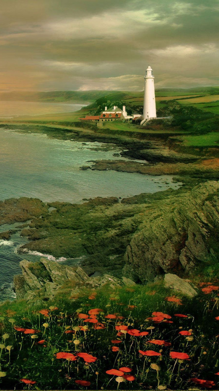 White Lighthouse on Green Grass Field Near Body of Water During Sunset. Wallpaper in 750x1334 Resolution