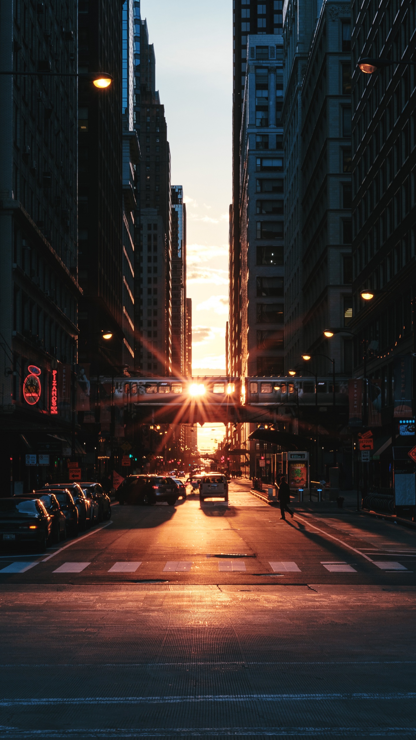 Autos Auf Der Straße Zwischen Hochhäusern Während Der Nacht. Wallpaper in 1440x2560 Resolution