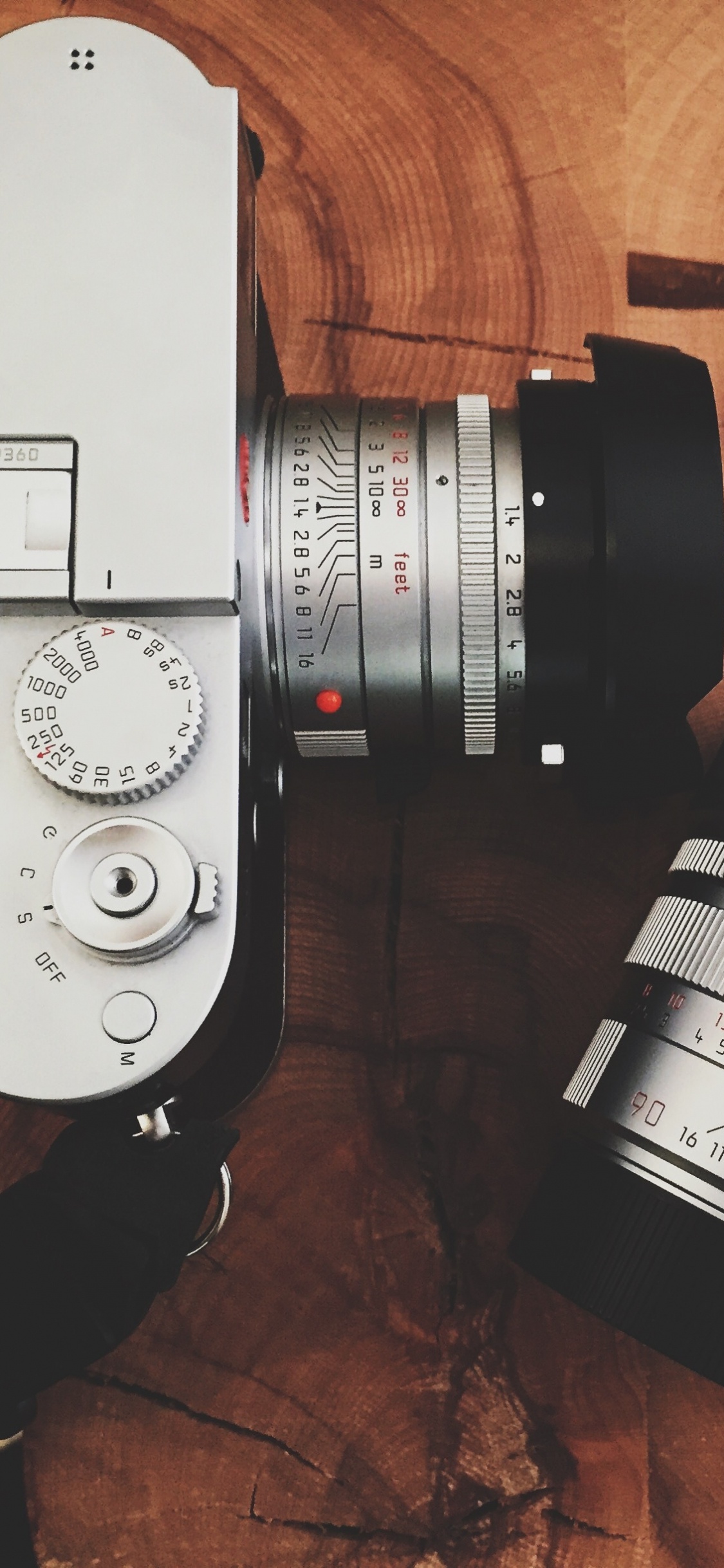 Black and Silver Dslr Camera Beside Black and White Coffee Cup. Wallpaper in 1125x2436 Resolution