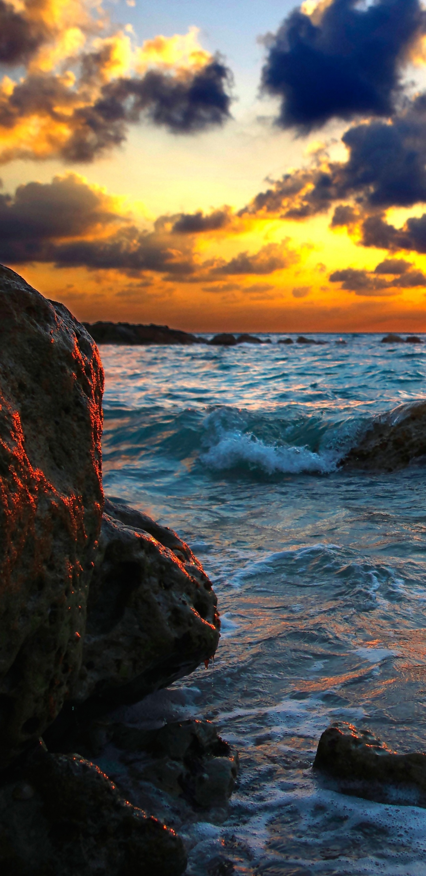 Rocky Shore Under Cloudy Sky During Sunset. Wallpaper in 1440x2960 Resolution