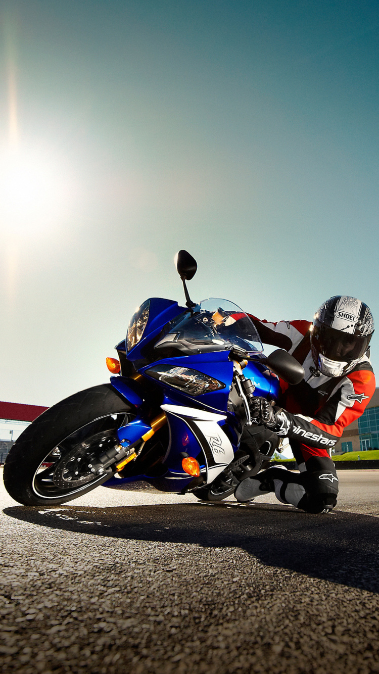 Homme en Costume de Moto Noir et Orange à Cheval Sur un Vélo de Sport Orange et Noir. Wallpaper in 750x1334 Resolution