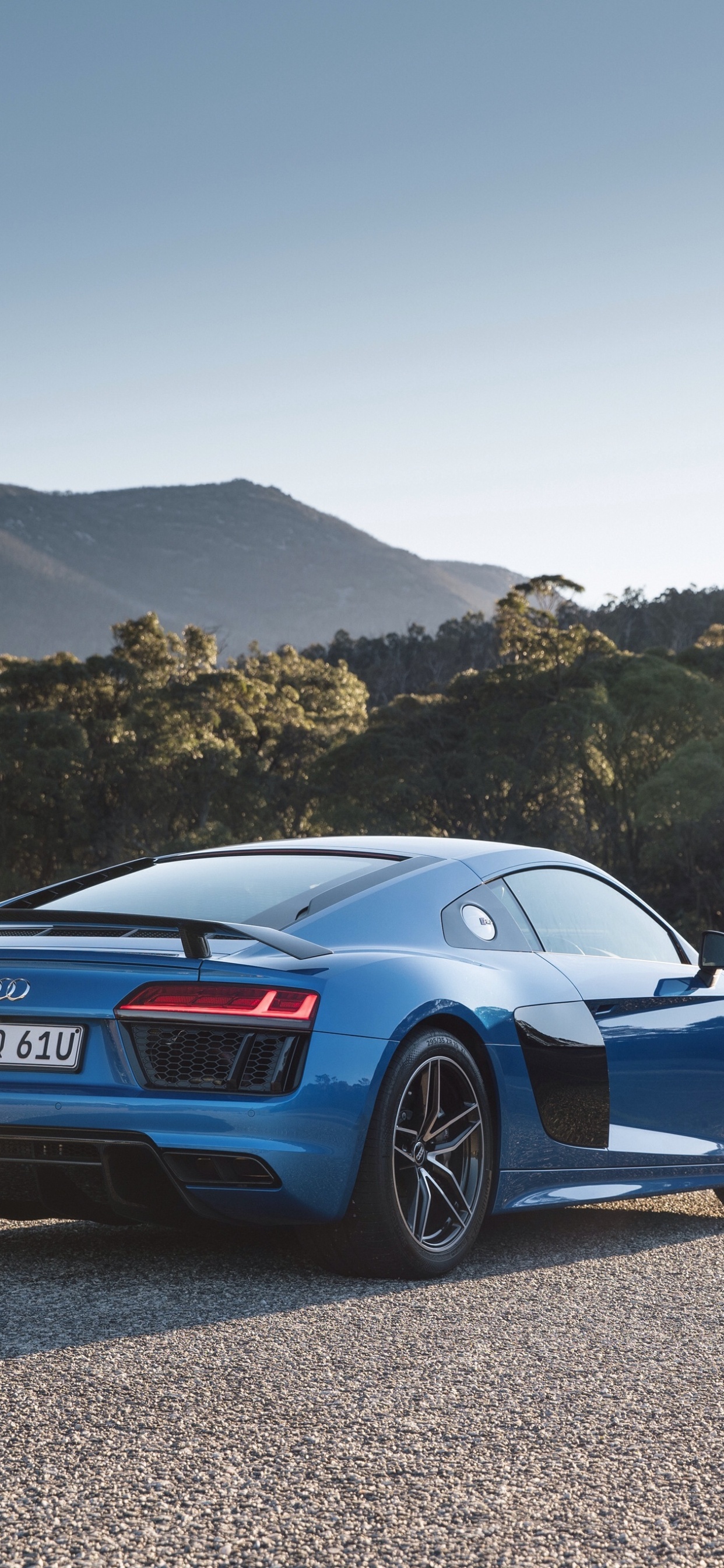 Blue Porsche 911 on Gray Dirt Road During Daytime. Wallpaper in 1242x2688 Resolution