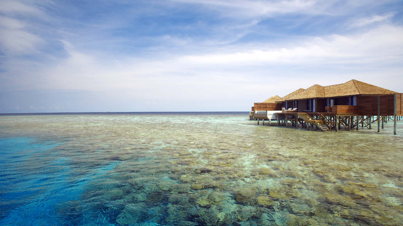 Brown Wooden House on Body of Water Under Blue Sky During Daytime. Wallpaper in 1280x720 Resolution