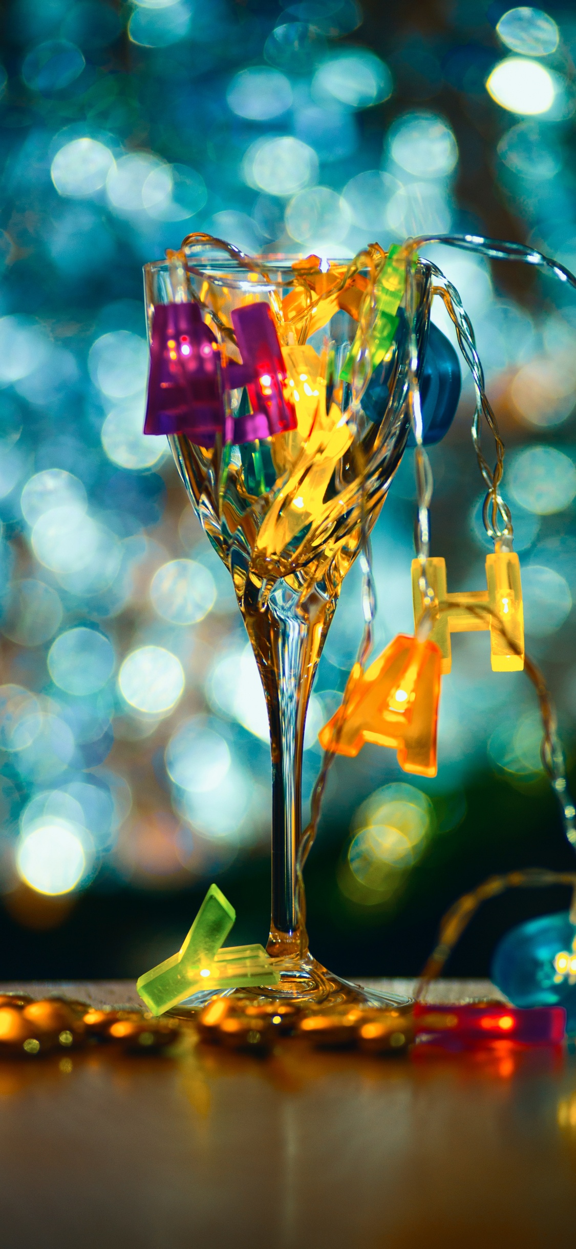 Clear Glass Vase With Yellow and Pink Heart Shaped Candies. Wallpaper in 1125x2436 Resolution