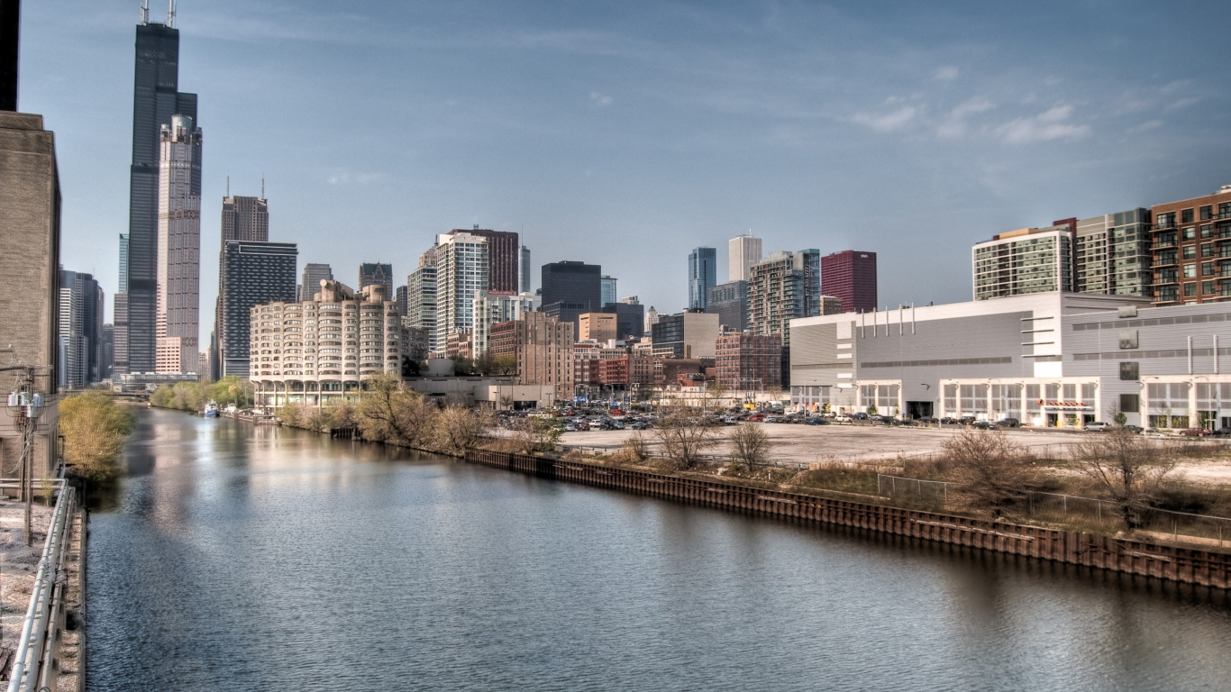 City Buildings Near Body of Water During Daytime. Wallpaper in 1366x768 Resolution