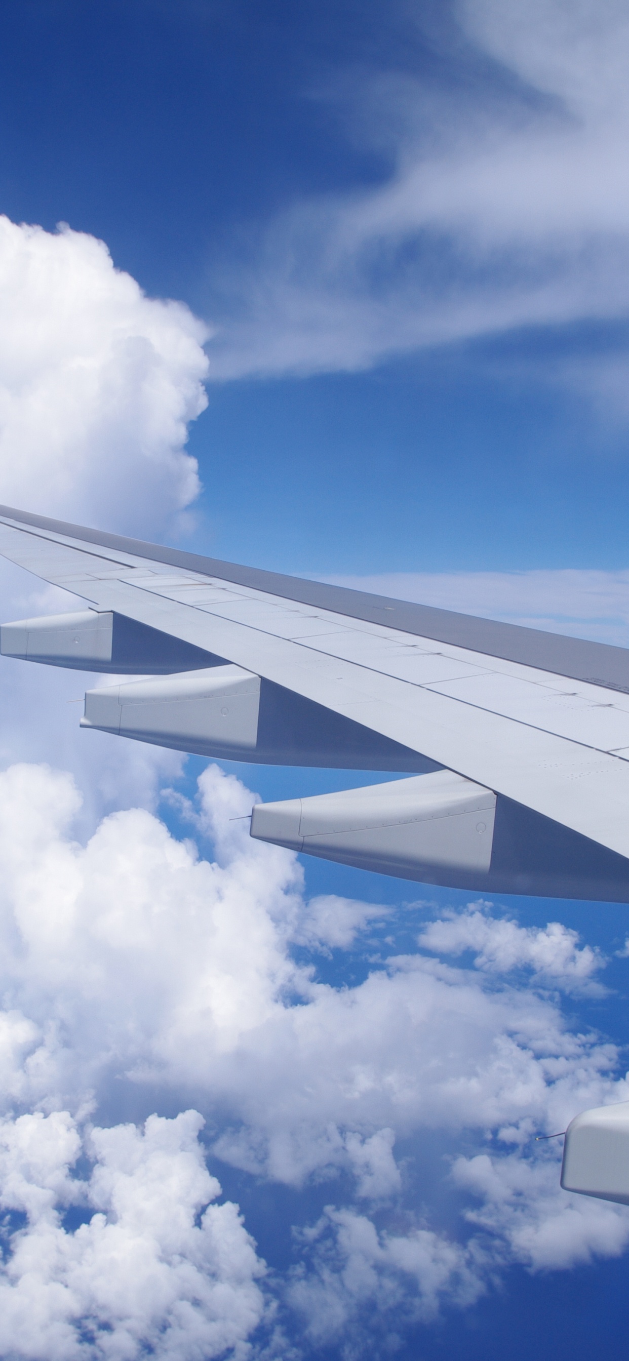 White and Red Airplane Wing Under Blue Sky and White Clouds During Daytime. Wallpaper in 1242x2688 Resolution