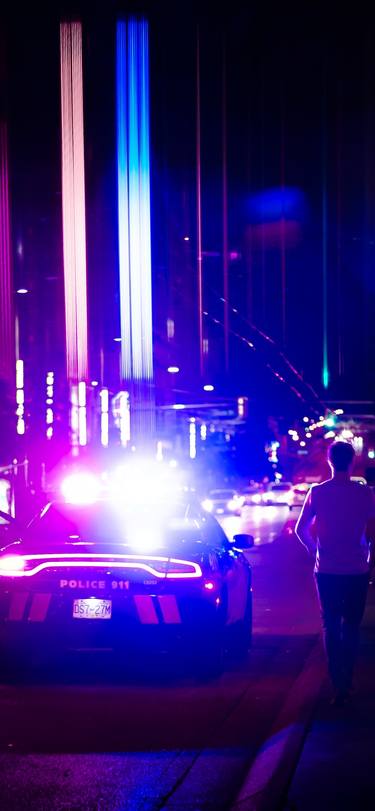 Man in Black Jacket and Black Pants Standing on Sidewalk During Night Time. Wallpaper in 1242x2688 Resolution