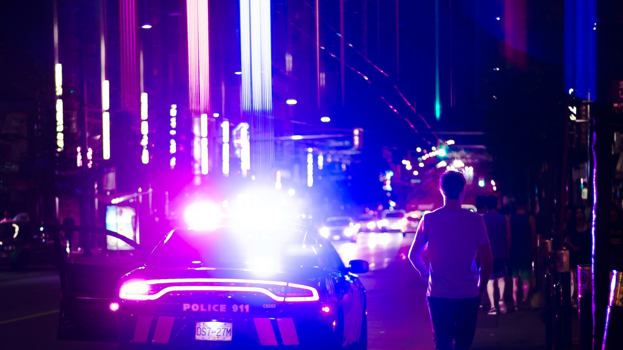 Man in Black Jacket and Black Pants Standing on Sidewalk During Night Time. Wallpaper in 1280x720 Resolution