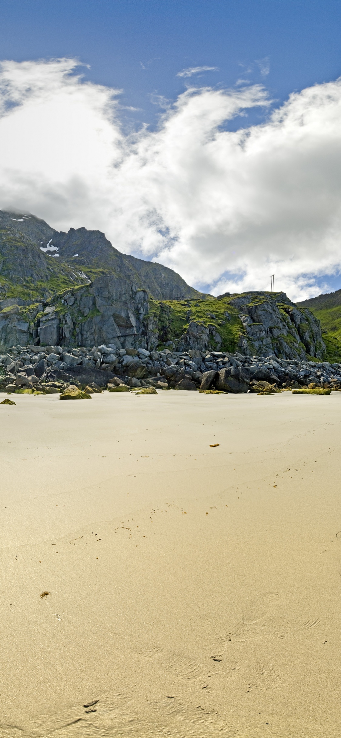 Green Mountain Beside Body of Water During Daytime. Wallpaper in 1125x2436 Resolution