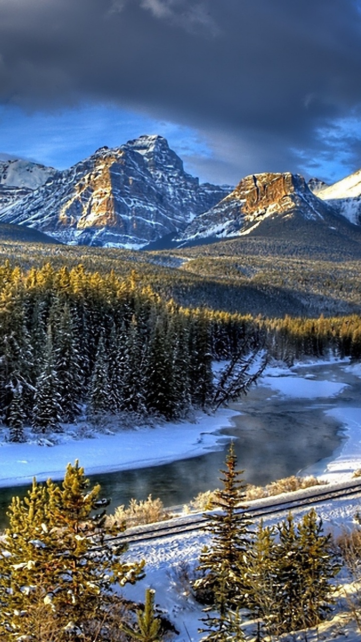 Green Pine Trees Near Snow Covered Mountain Under Blue Sky During Daytime. Wallpaper in 720x1280 Resolution