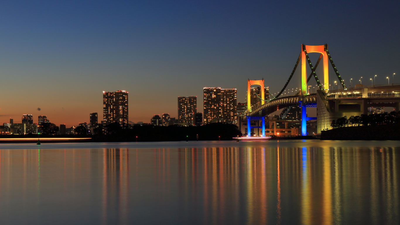 Lighted Bridge Over Water During Night Time. Wallpaper in 1366x768 Resolution