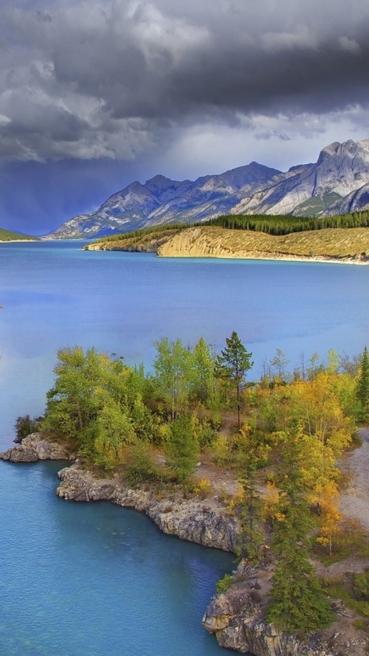 Green Trees Near Lake Under Blue Sky During Daytime. Wallpaper in 720x1280 Resolution