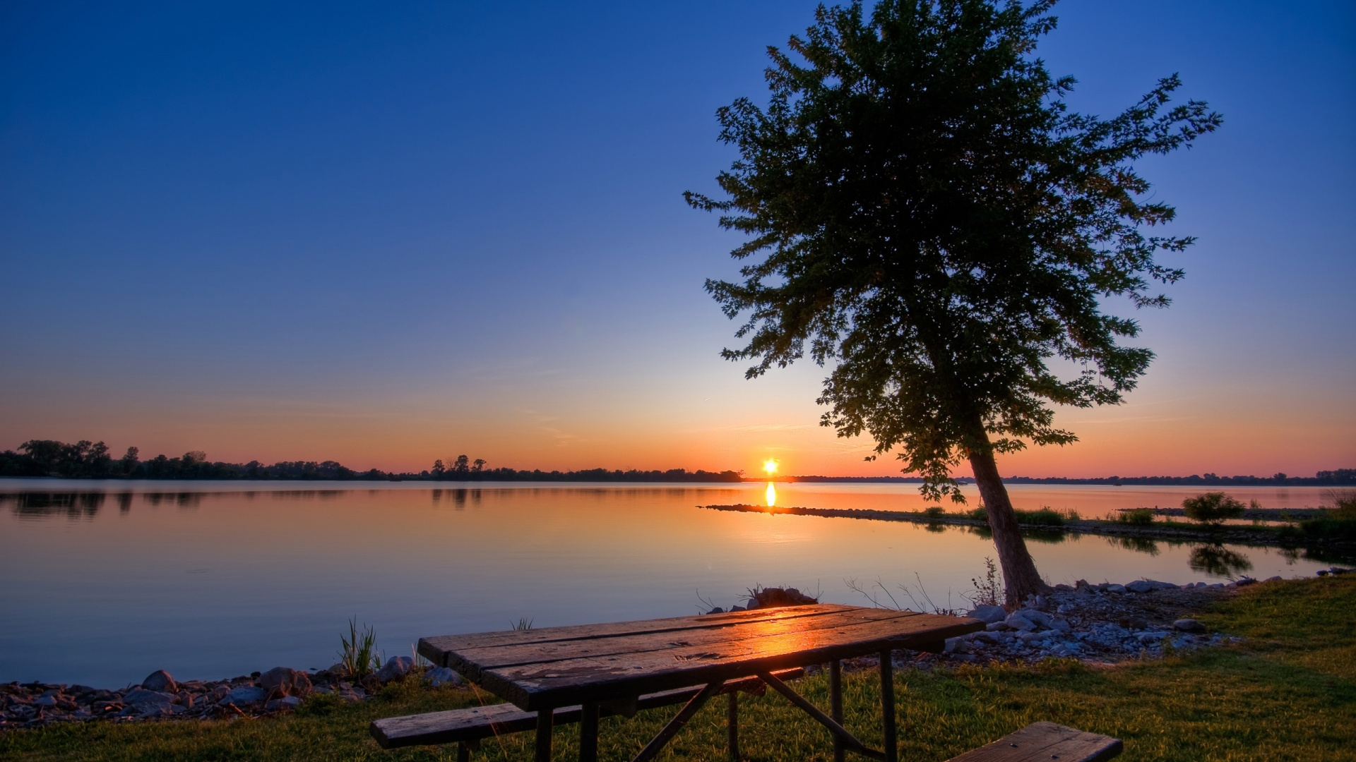 Brown Wooden Bench Near Body of Water During Sunset. Wallpaper in 1920x1080 Resolution