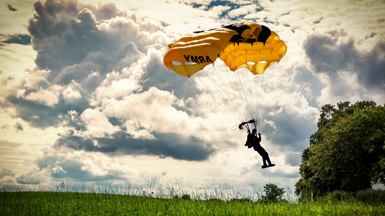 Person in Black Jacket and Pants Riding Yellow Parachute Under White Clouds During Daytime. Wallpaper in 1280x720 Resolution