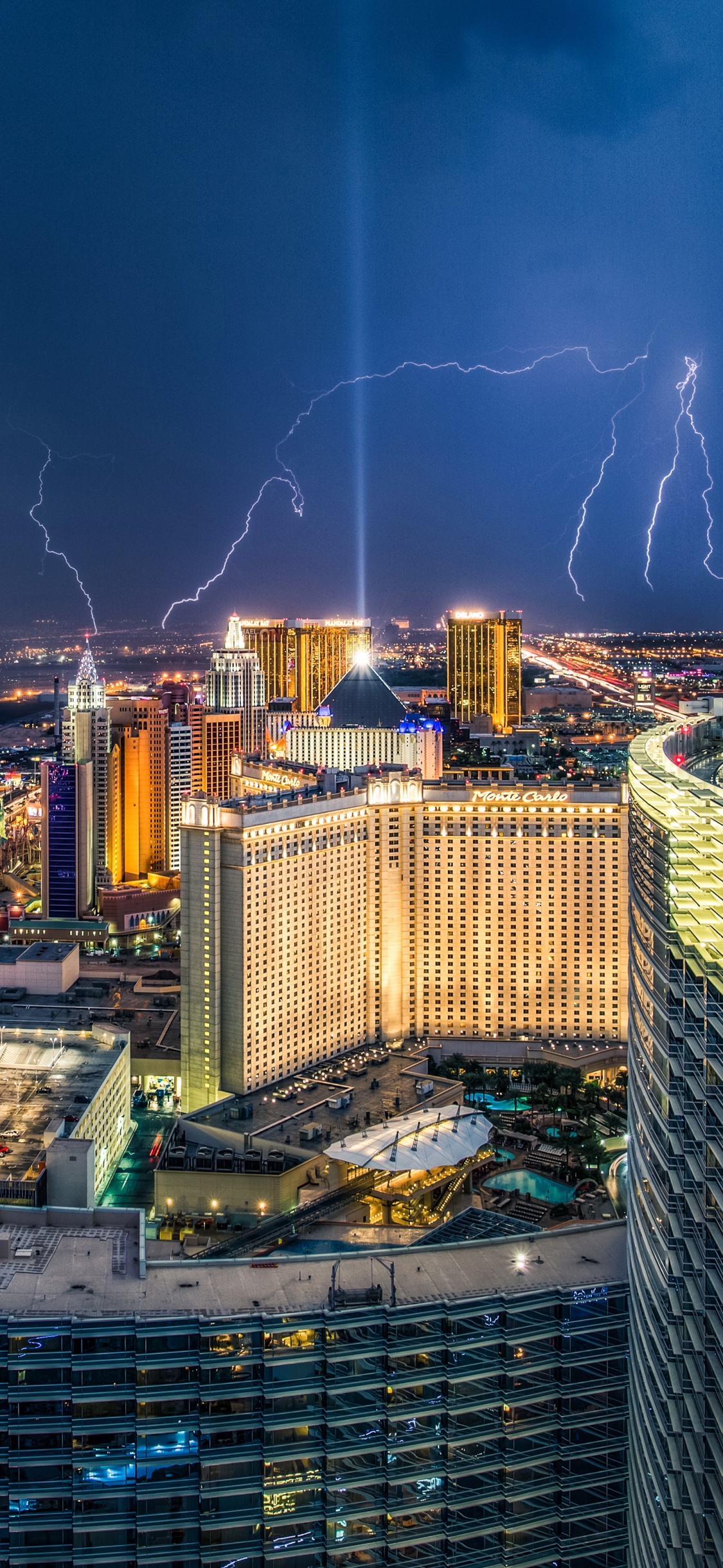 City With High Rise Buildings During Night Time. Wallpaper in 1125x2436 Resolution