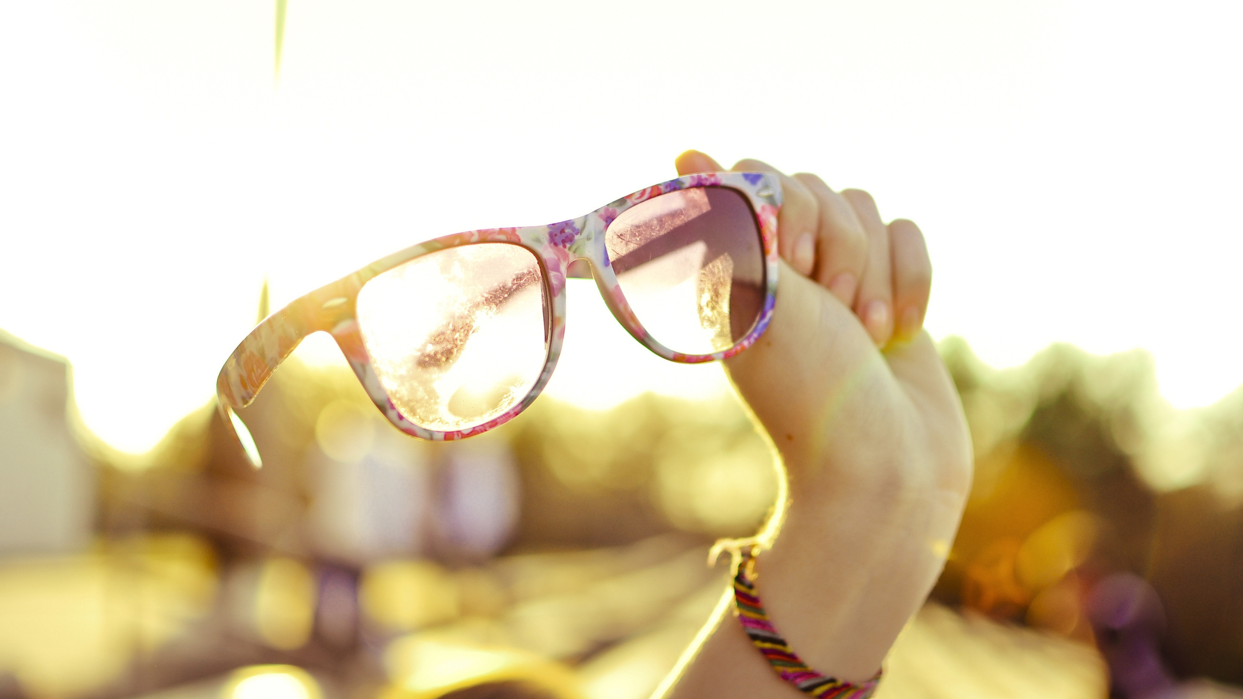 Person Holding Brown Framed Eyeglasses. Wallpaper in 2560x1440 Resolution