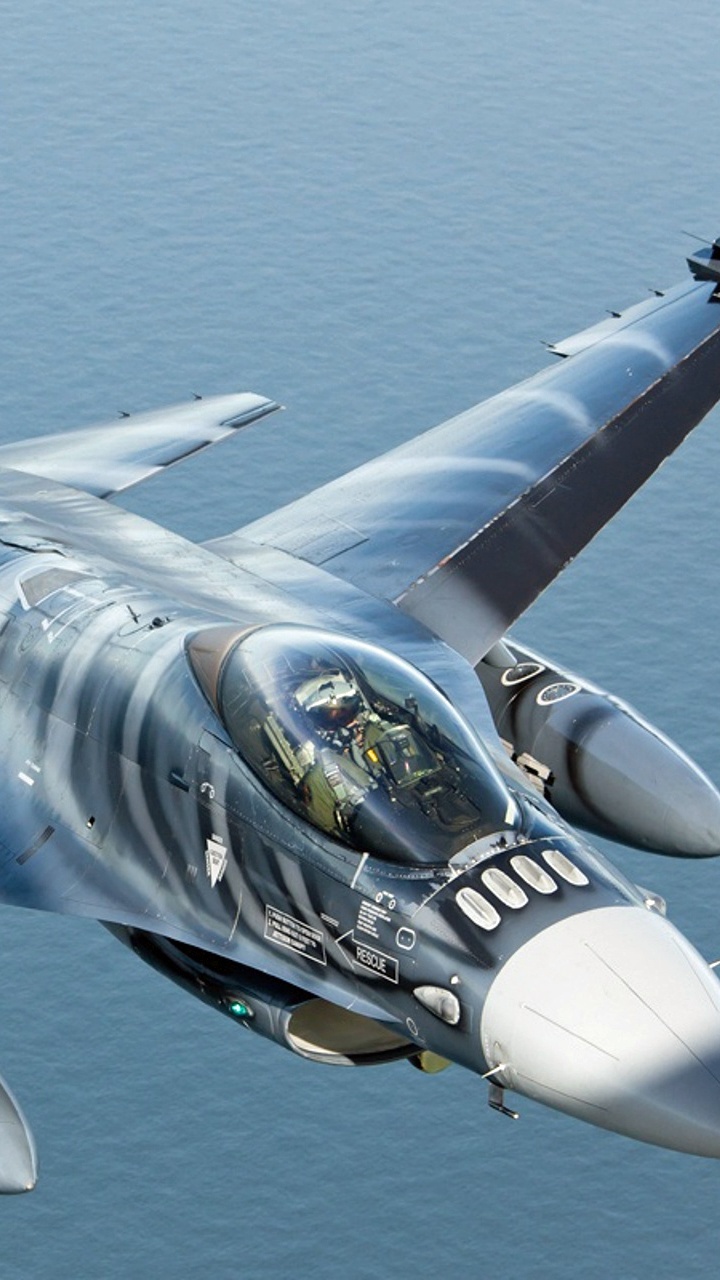 Blue and White Jet Plane Flying Over Blue Sea During Daytime. Wallpaper in 720x1280 Resolution