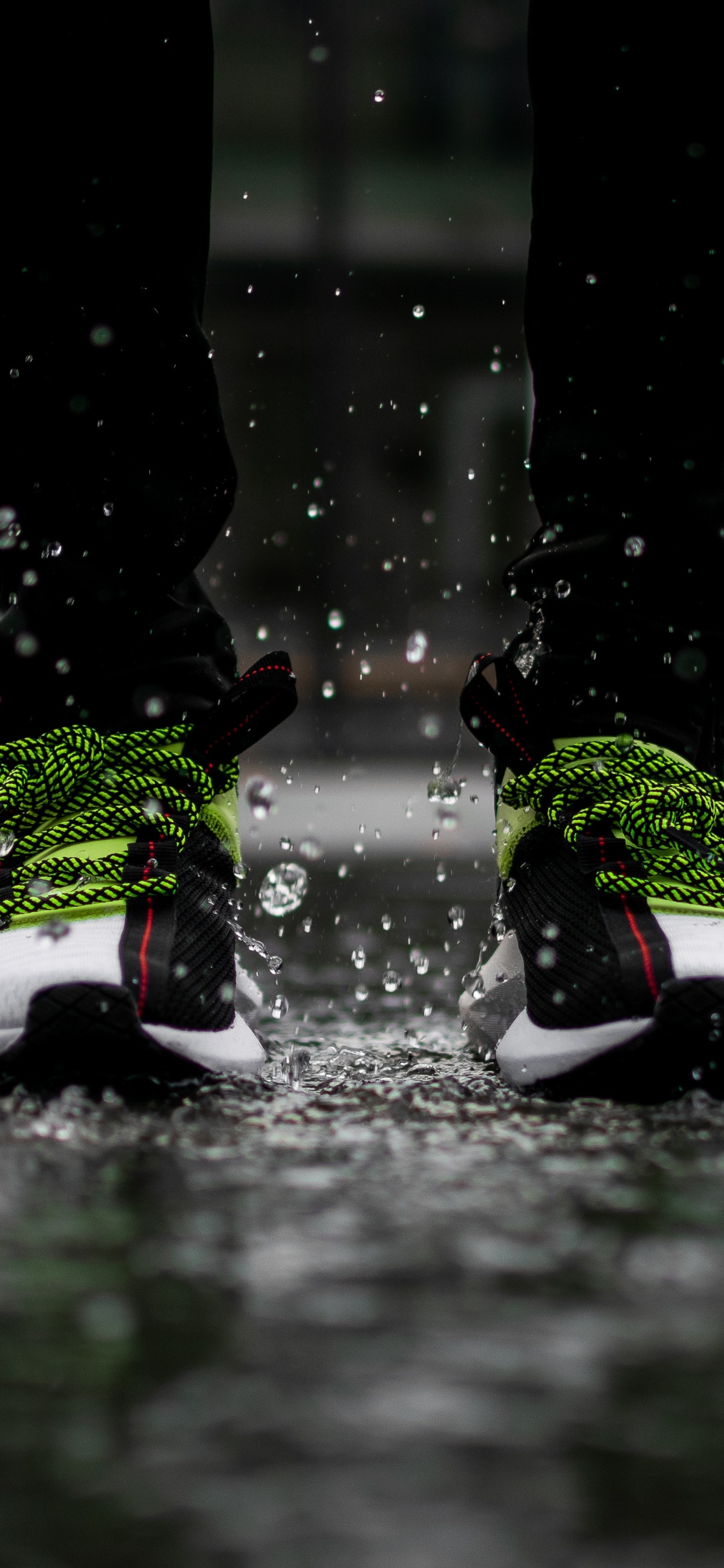 Person in Black Pants Wearing White Red and Black Nike Sneakers. Wallpaper in 1125x2436 Resolution