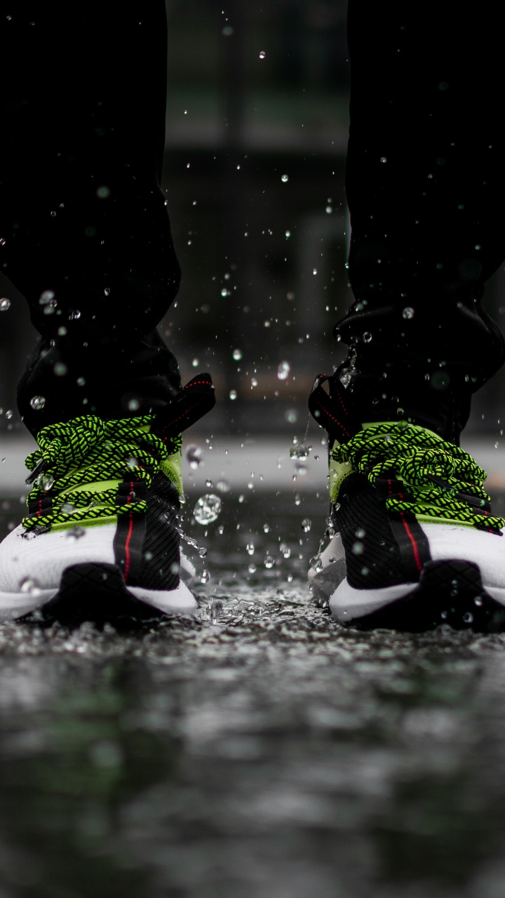 Person in Black Pants Wearing White Red and Black Nike Sneakers. Wallpaper in 720x1280 Resolution