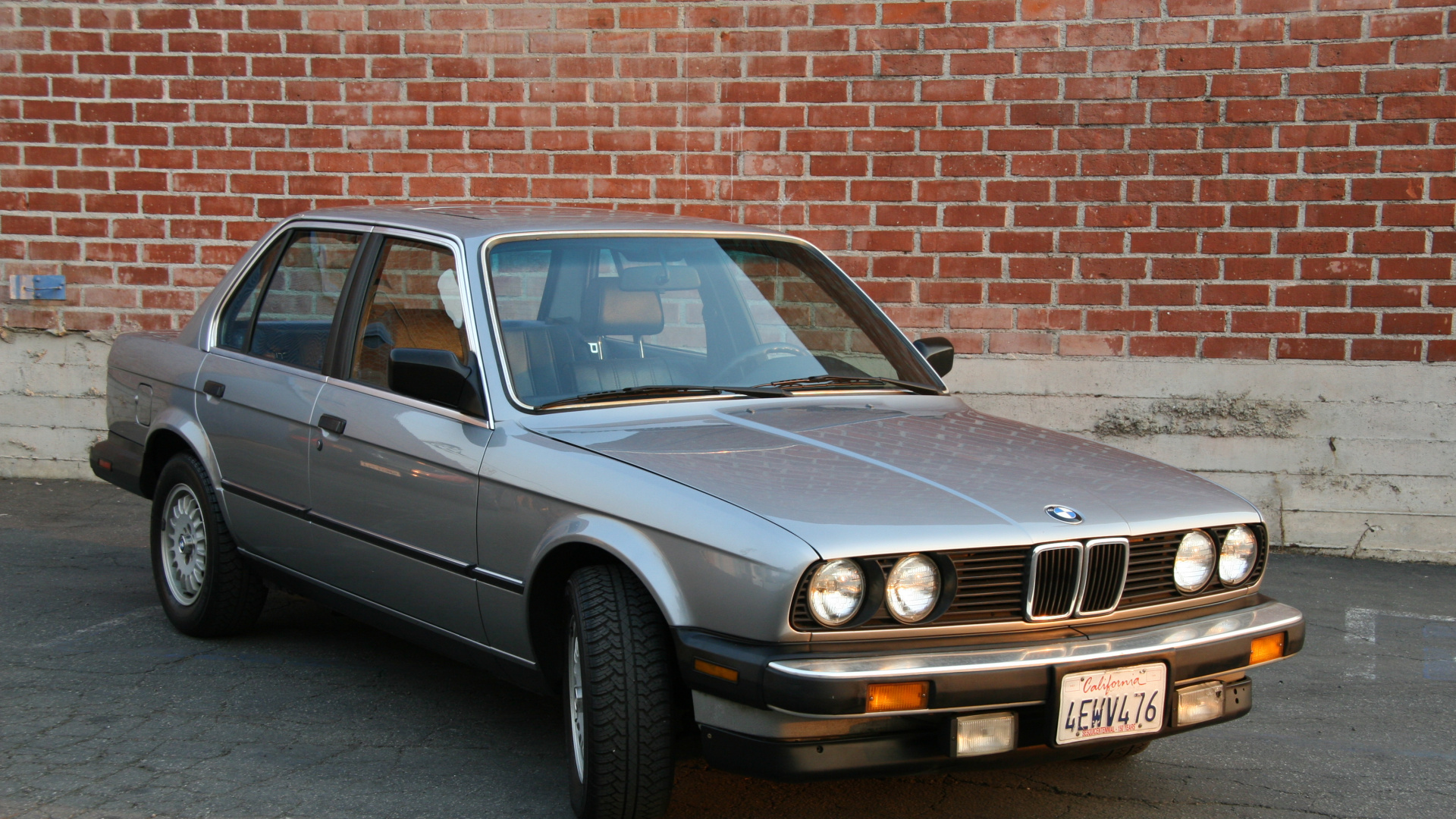 Black Mercedes Benz Coupe Parked Beside Brown Brick Wall. Wallpaper in 1920x1080 Resolution