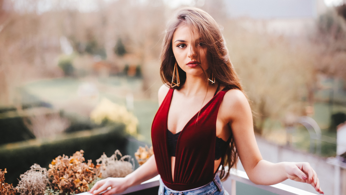 Woman in Red Tank Top and Blue Denim Shorts Standing Beside White Wooden Railings During Daytime. Wallpaper in 1366x768 Resolution