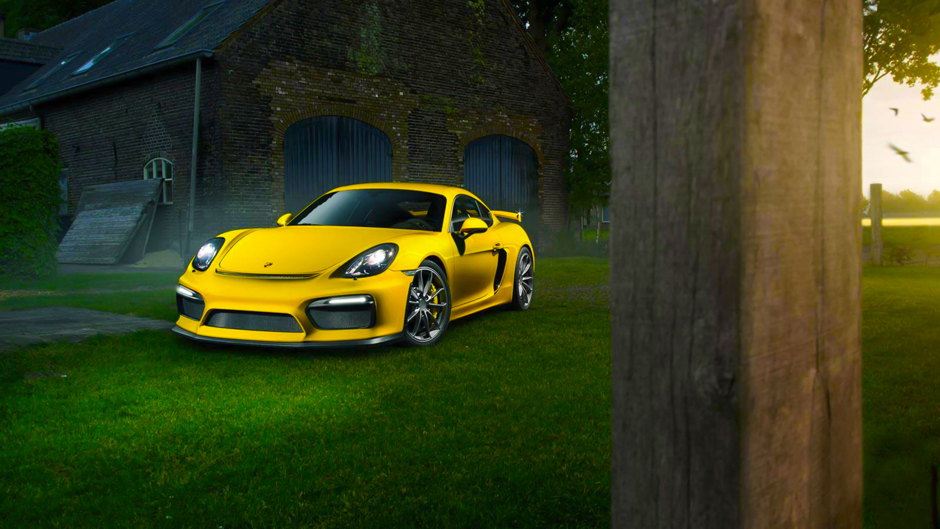 Yellow Porsche 911 Parked Beside Brown Brick Building. Wallpaper in 1920x1080 Resolution
