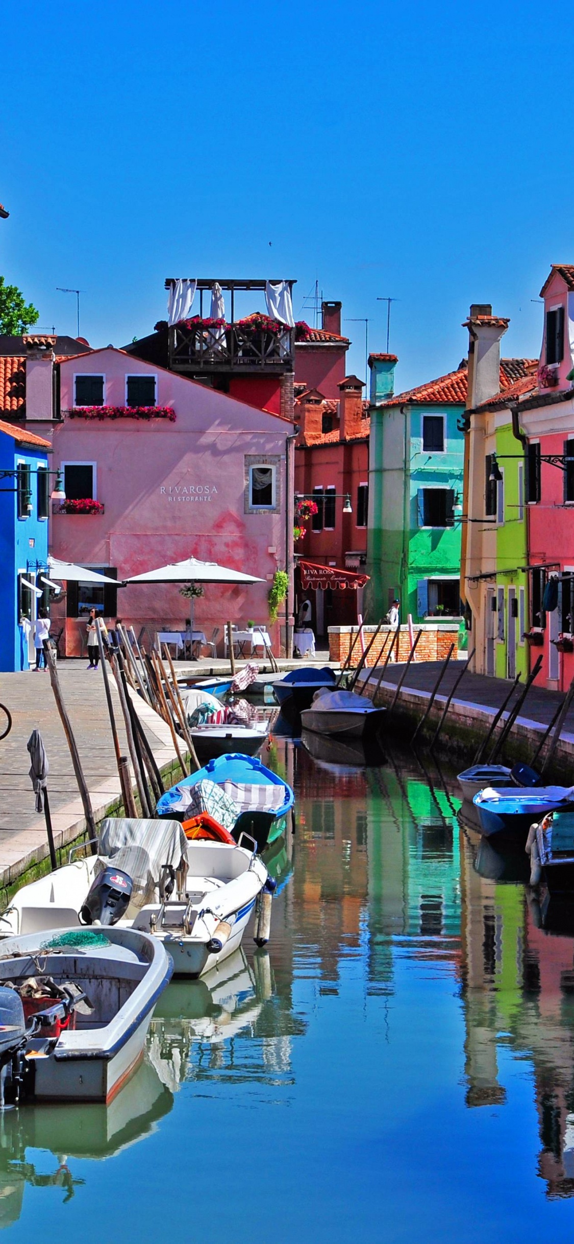 Boat on Dock Near Houses During Daytime. Wallpaper in 1125x2436 Resolution