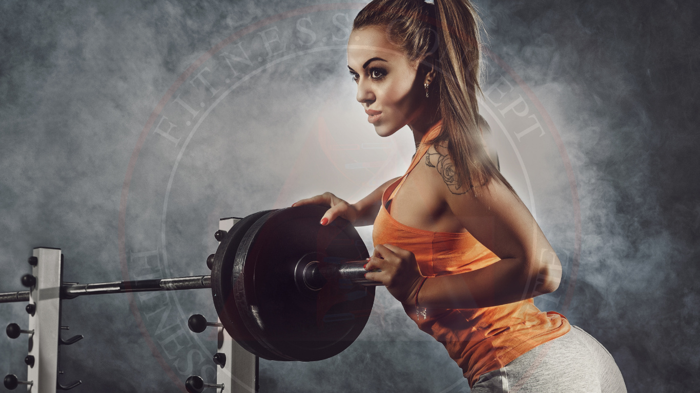 Woman in Orange Tank Top and Gray Shorts Holding Black Dumbbell. Wallpaper in 1366x768 Resolution