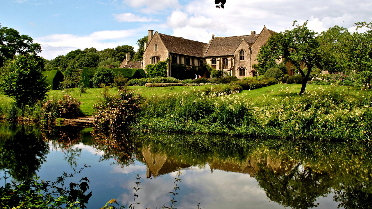 Maison Brune et Blanche Près du Champ D'herbe Verte et du Lac Sous un Ciel Bleu Pendant la Journée. Wallpaper in 1280x720 Resolution