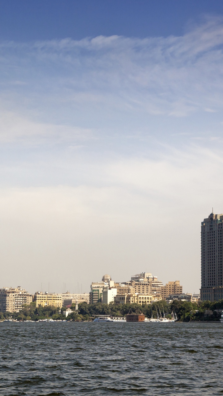 City Skyline Across Body of Water During Daytime. Wallpaper in 720x1280 Resolution