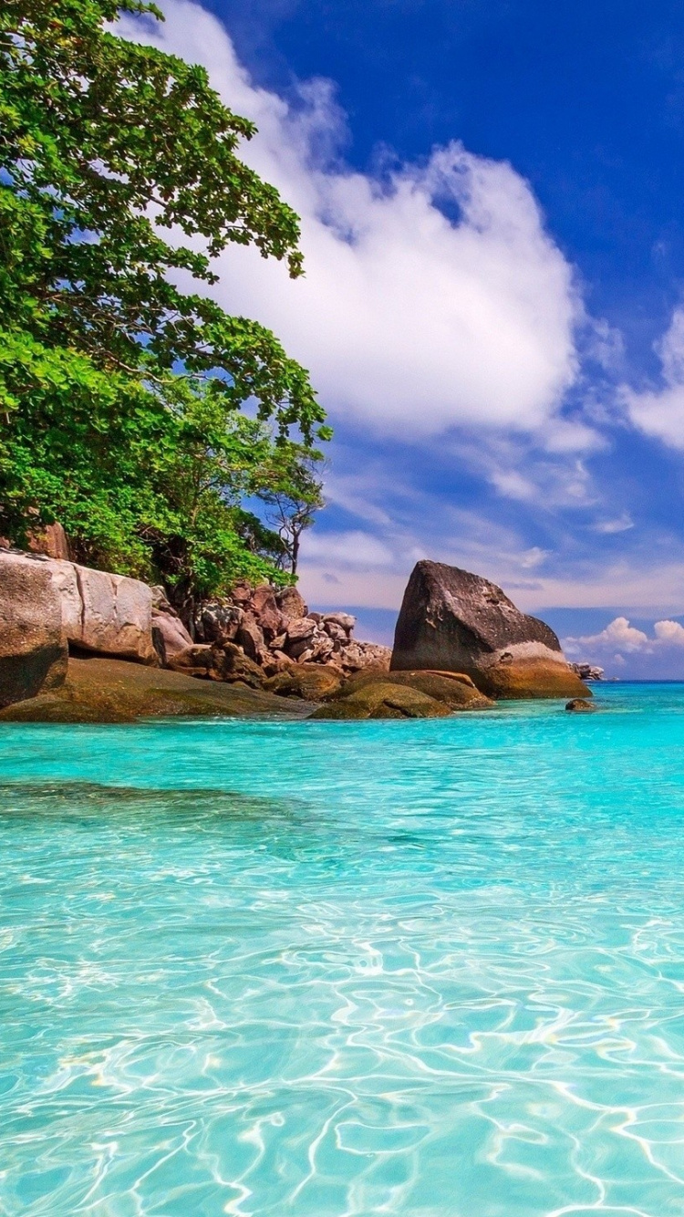 Brown Rock Formation on Blue Sea Under Blue Sky and White Clouds During Daytime. Wallpaper in 750x1334 Resolution