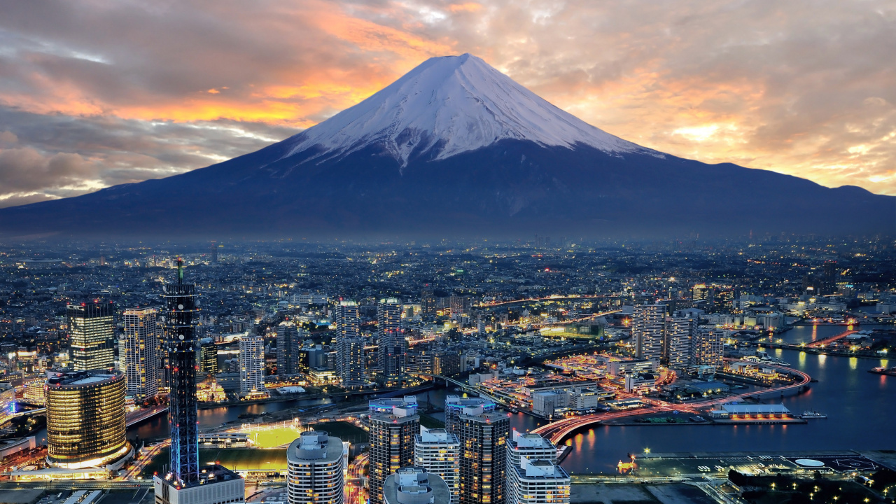 Aerial View of City Buildings Near Snow Covered Mountain During Daytime. Wallpaper in 1280x720 Resolution